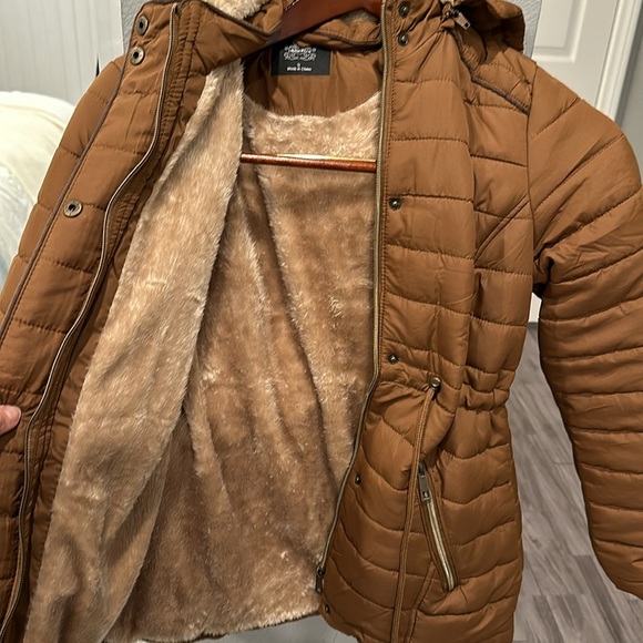 A Brown Puffer Jacket with tightness Adjustability and a removable hoodie. - Picture 2 of 5